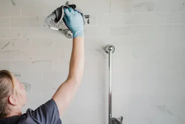 Merry Maids team member cleaning a bathroom.
