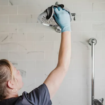 Merry Maids team member cleaning bathroom.