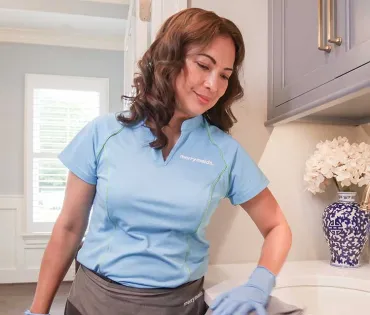Merry Maids team member cleaning sink