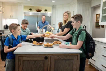Family getting ready for school in a clean kitchen