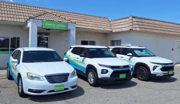 merry maids vehicles parked outside of a merry maids office