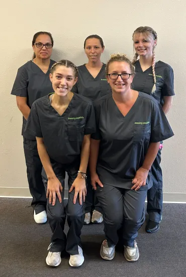 group of merry maids smiling wearing grey uniforms