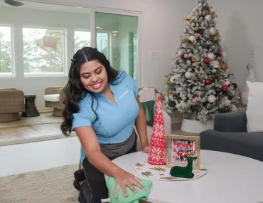 Cleaning in front of Christmas tree