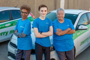 merry maids standing in front of a branded vehicle