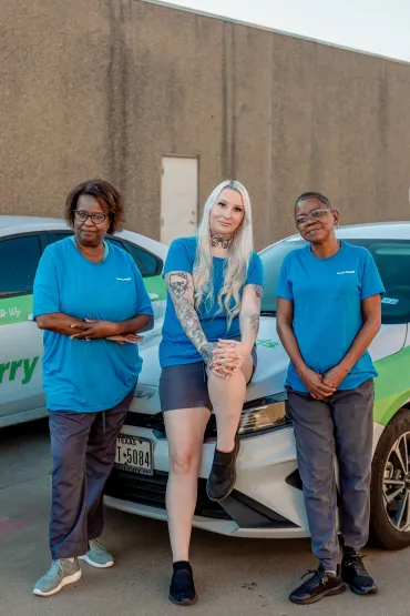 merry maids standing in front of a branded vehicle