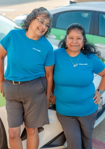 merry maids posing by a branded vehicle