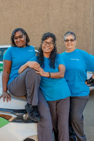 merry maids standing in front of a branded vehicle