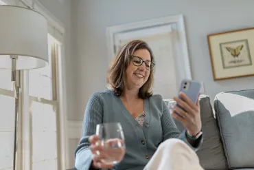 woman relaxing on couch looking at phone