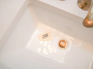 clean bathroom sink with merry maids card