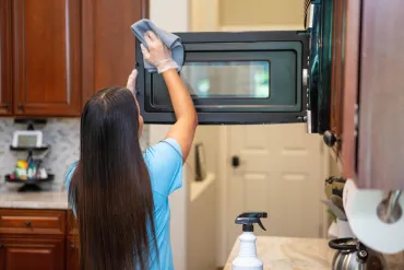 merry maid cleaning a microwave