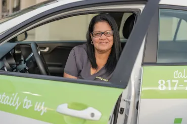 merry maids posing by branded vehicles