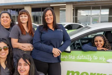 merry maids posing by branded vehicles