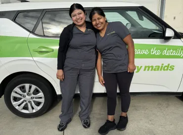 merry maids standing by branded vehicle