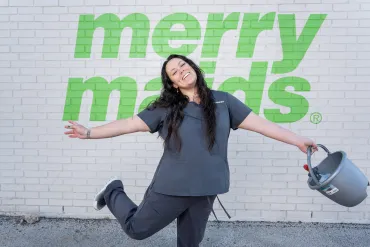 merry maids posing by a white brick wall