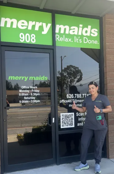 Merry maid standing by storefront