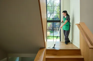 Merry maid cleaning stairwell