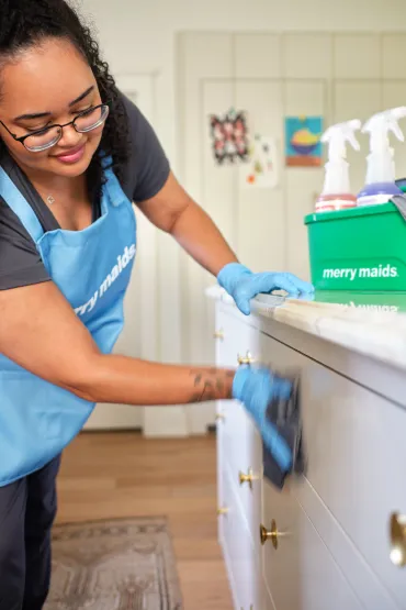 merry maid wiping cabinets