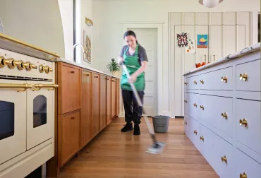 merry maid mopping the floor