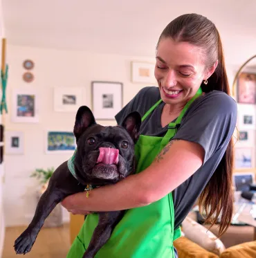 merry maid playing with dog