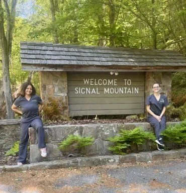 merry maids posing by the signal mountain welcome sign