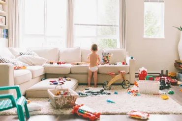 Boy playing with scattered toys everywhere