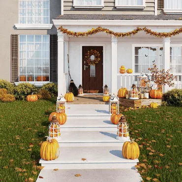 House decorated for Halloween with fall leaves in yard.